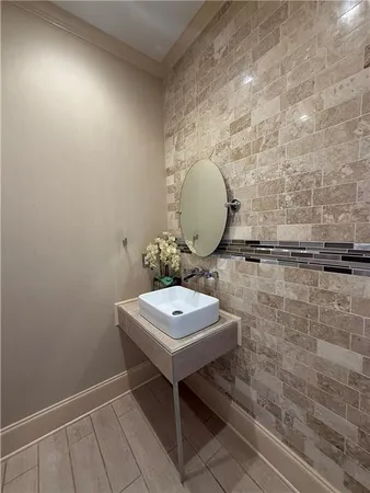 a bathroom with a toilet and a mirror