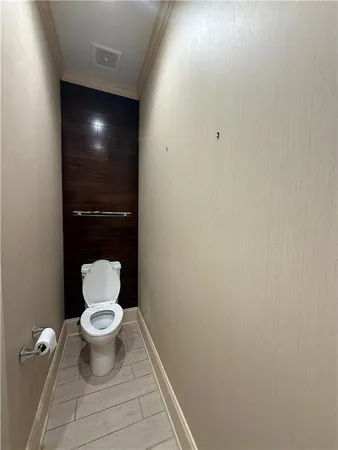 a view of wooden floor chandelier and windows in a room