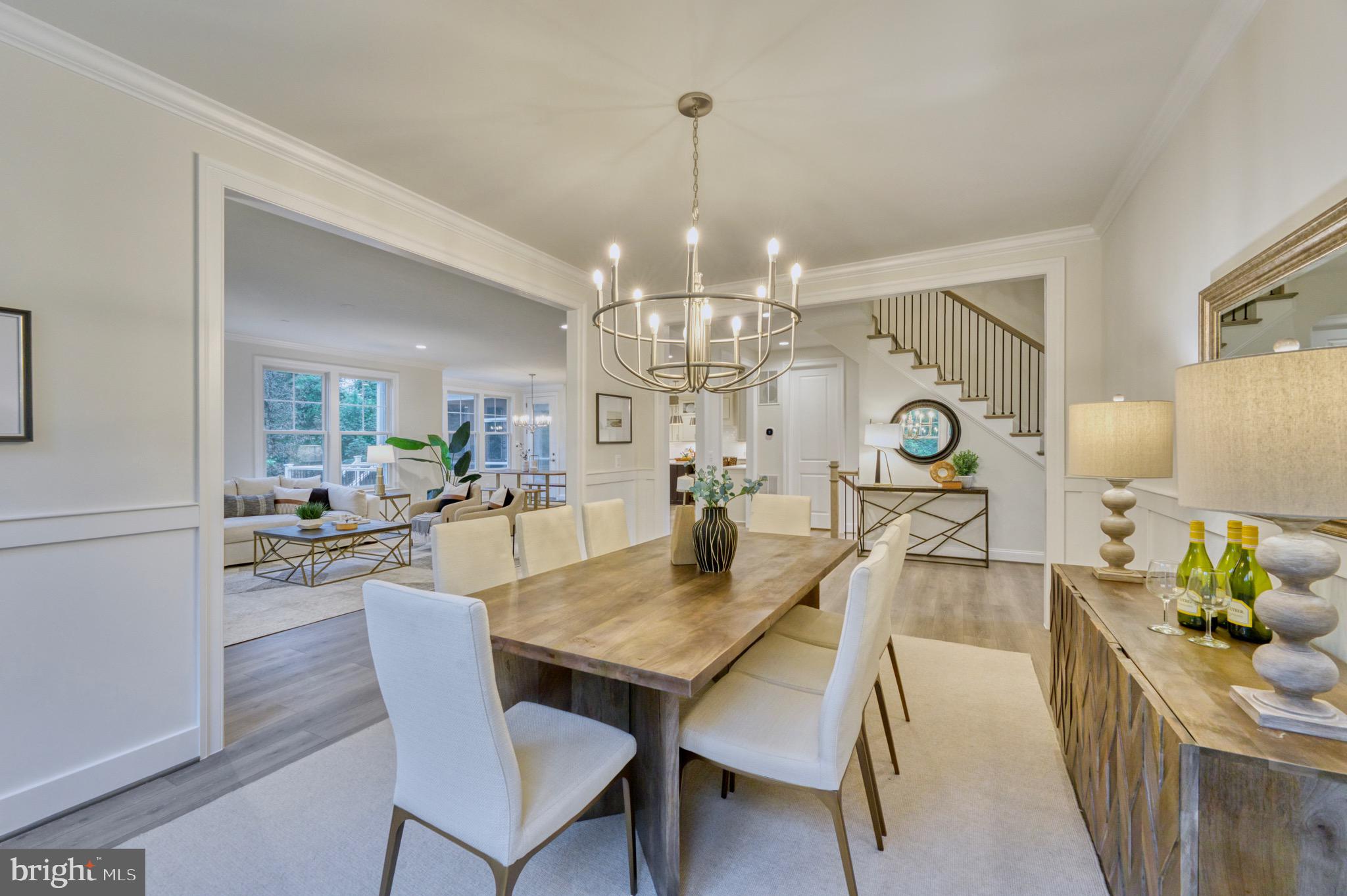 2236 Laurel Ridge Road Vienna, VA 22181 - Photo 14 of 78 a view of a dining room and livingroom with furniture wooden floor a rug a potted plant and a chandelier