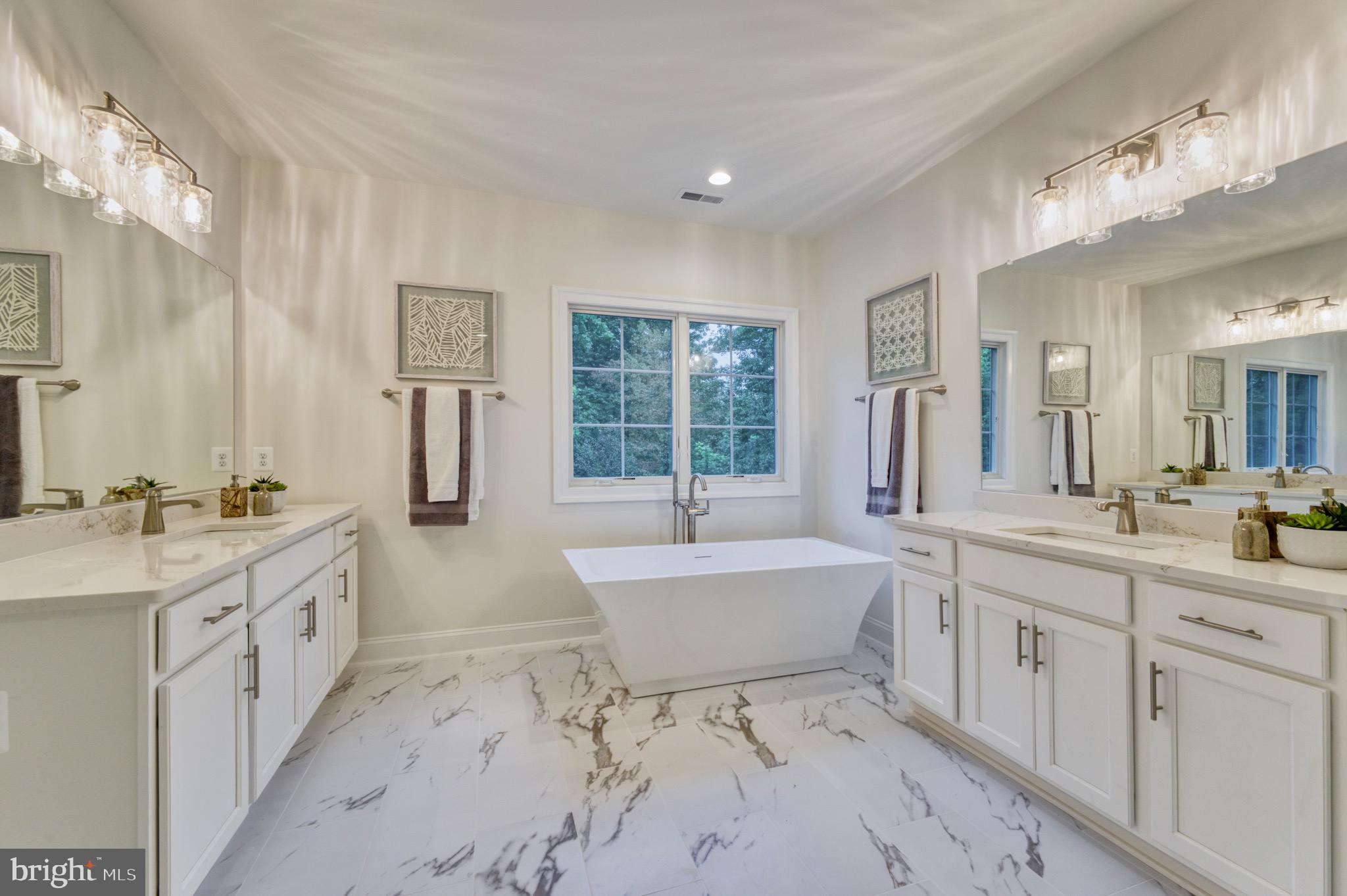 2236 Laurel Ridge Road Vienna, VA 22181 - Photo 34 of 78 a spacious bathroom with a double vanity sink a large mirror and a bathtub