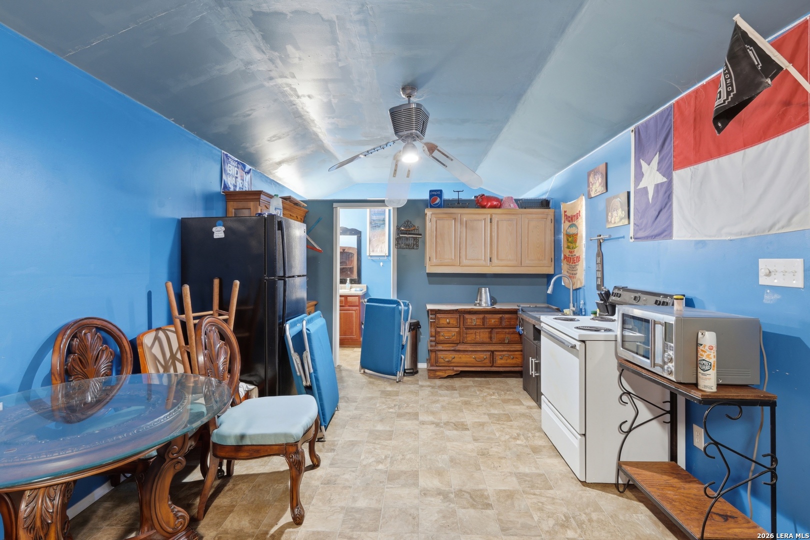 2145 Fm 2504 Poteet, TX 78065 - Photo 23 of 34 a kitchen that has a table chairs in it and wooden floors