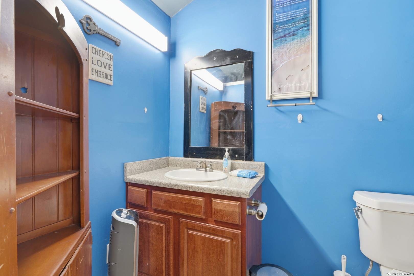 2145 Fm 2504 Poteet, TX 78065 - Photo 26 of 34 a bathroom with a sink a toilet and mirror