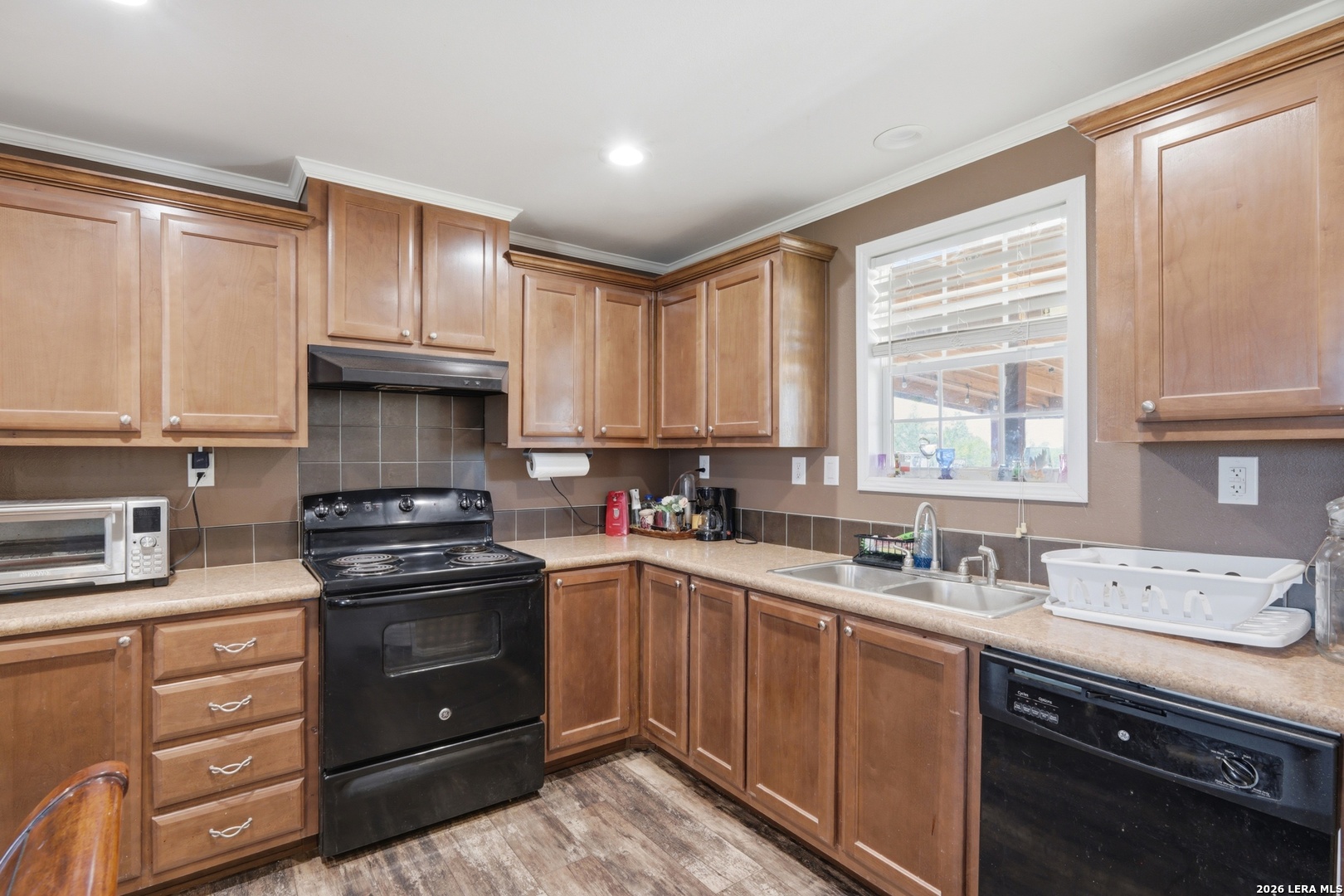 2145 Fm 2504 Poteet, TX 78065 - Photo 8 of 34 a kitchen with a sink stove top oven and cabinets