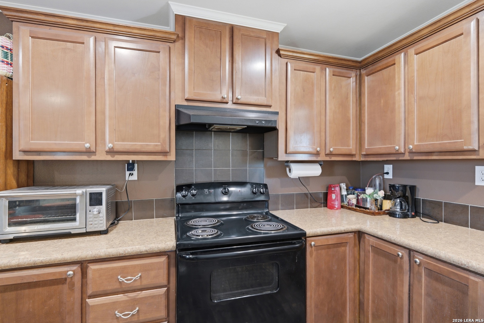 2145 Fm 2504 Poteet, TX 78065 - Photo 9 of 34 a kitchen with stainless steel appliances granite countertop white cabinets and a stove top oven