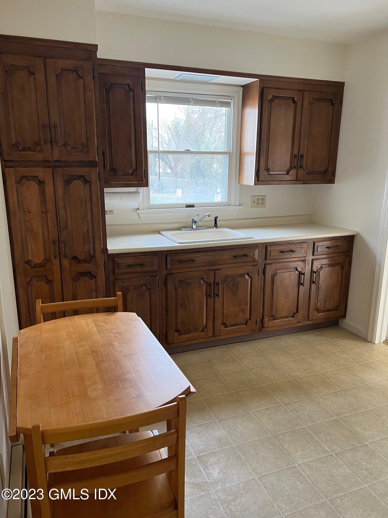 81 View Street West Greenwich, CT 06830 - Photo 2 of 12 a kitchen with stainless steel appliances a stove a sink cabinets and a window