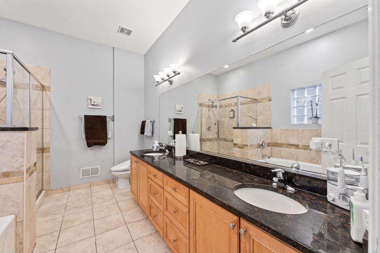 3106 South Wells Street, Unit 1 Chicago, IL 60616 - Photo 20 of 36 a spacious bathroom with a granite countertop double sink and mirror