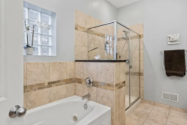 a kitchen with stainless steel appliances kitchen island granite countertop a refrigerator a stove and a sink with wooden cabinets