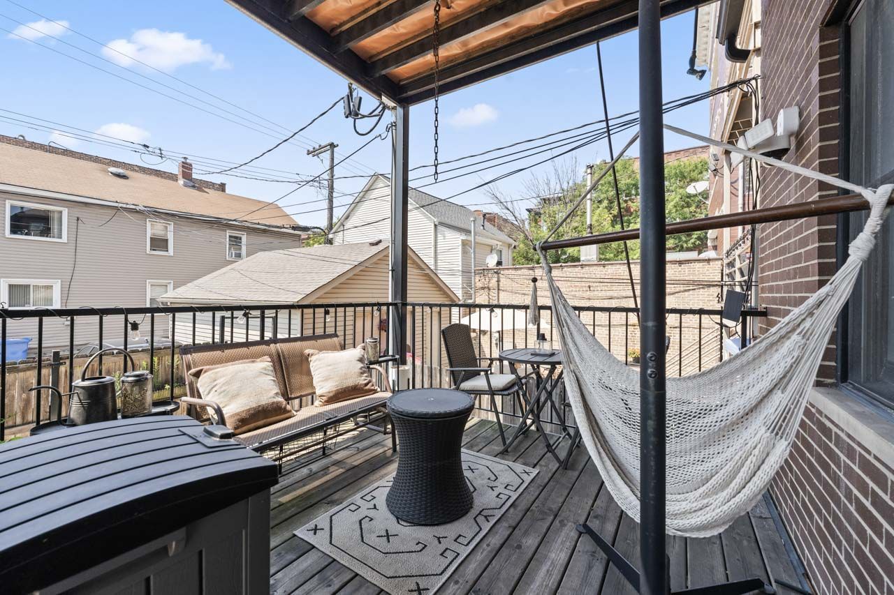 3106 South Wells Street, Unit 1 Chicago, IL 60616 - Photo 33 of 36 a view of balcony with wooden floor and outdoor seating