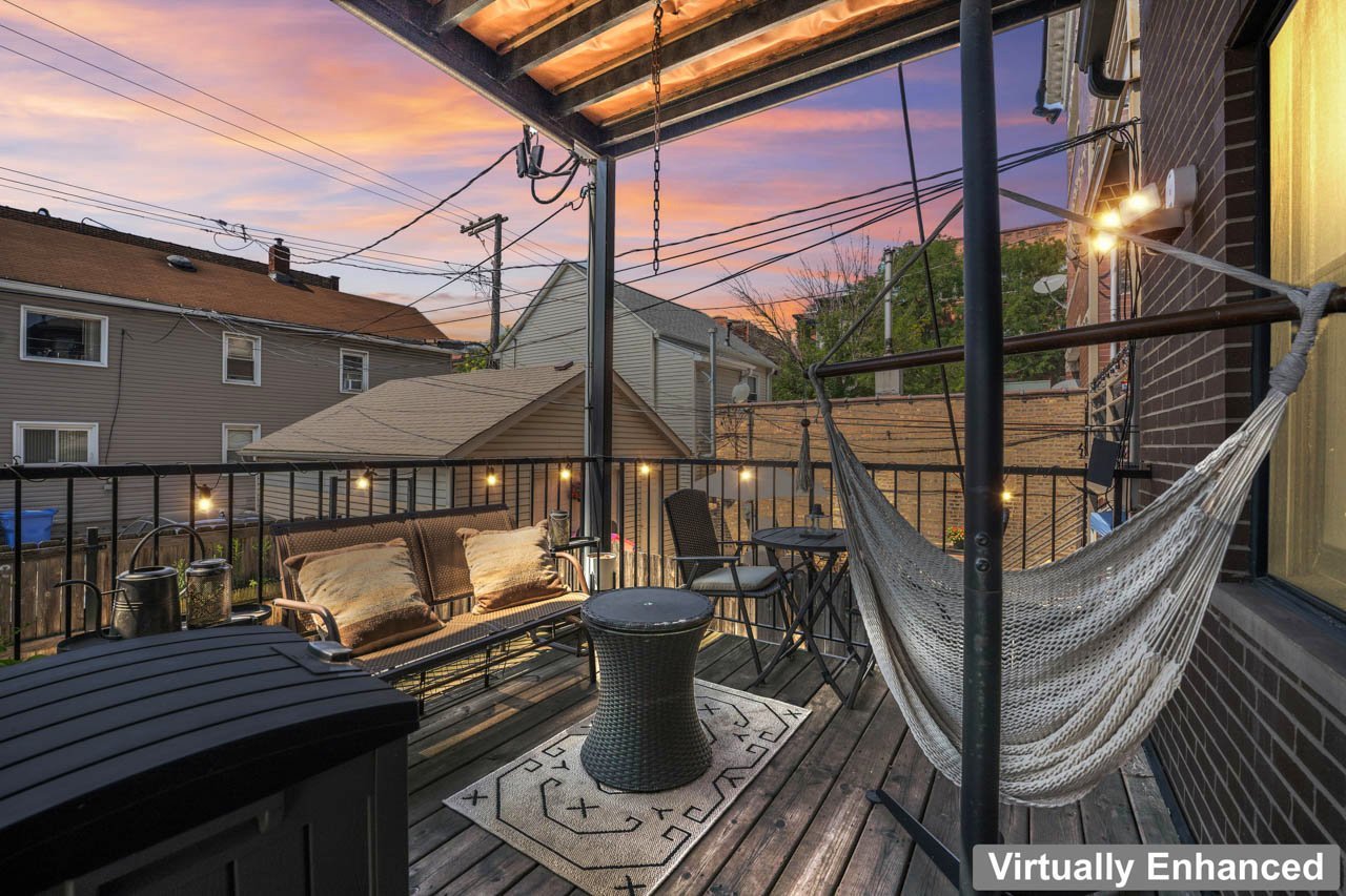 3106 South Wells Street, Unit 1 Chicago, IL 60616 - Photo 34 of 36 a roof deck with a dining table and chairs