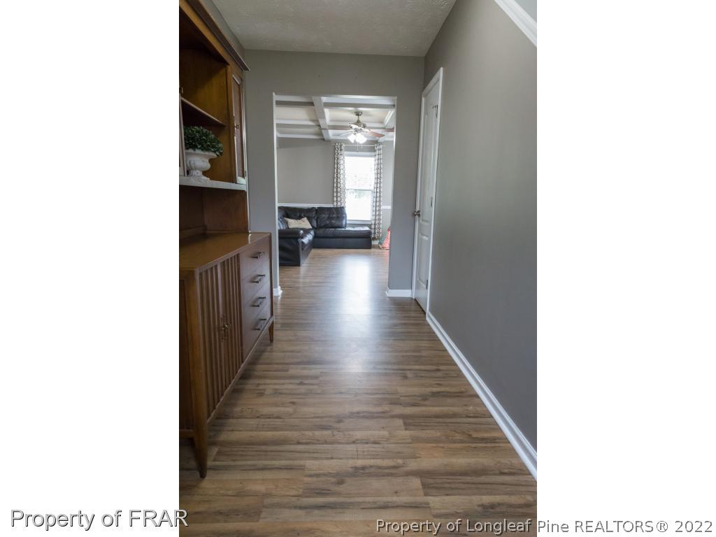 664 Cape Fear Road Raeford, NC 28376 - Photo 3 of 36 a view of a hallway with wooden floor and a living room