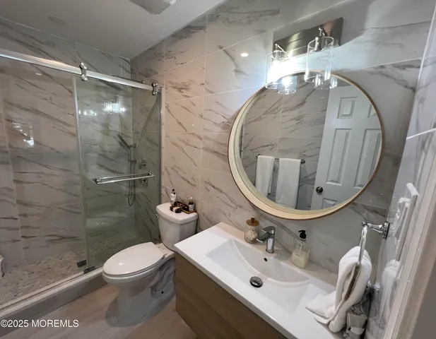 a bathroom with a sink toilet and shower