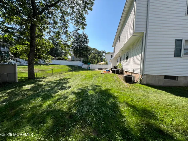 a view of backyard with swimming pool