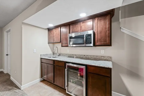 a kitchen with stainless steel appliances granite countertop a sink and a microwave