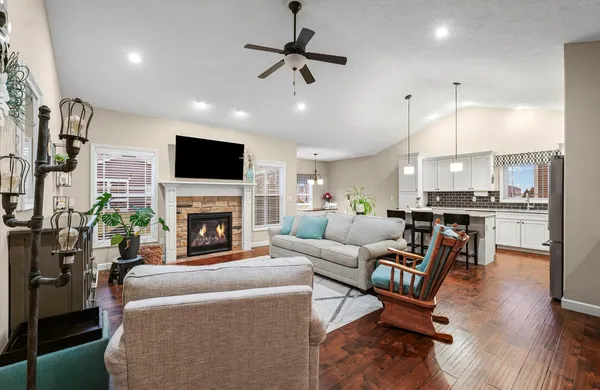 a living room with furniture a fireplace and a flat screen tv