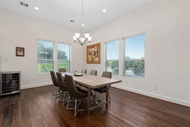 a view of a dining room with furniture wooden floor and chandelier