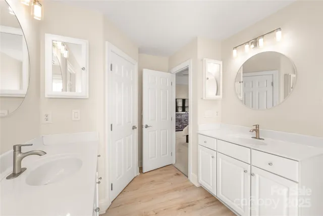 a spacious bathroom with a double vanity sink mirror and