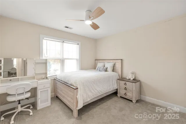 a bedroom with a bed and a table