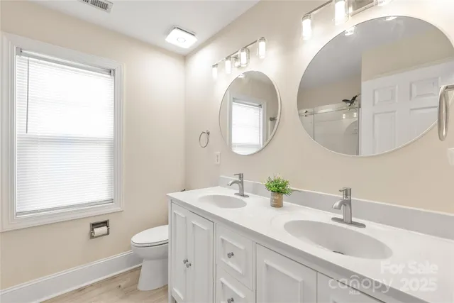 a bathroom with 2 sink and a mirror