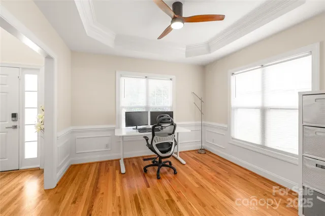 a workspace with wooden floor and windows