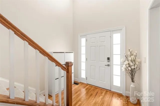 a view of entryway with wooden floor and stairs
