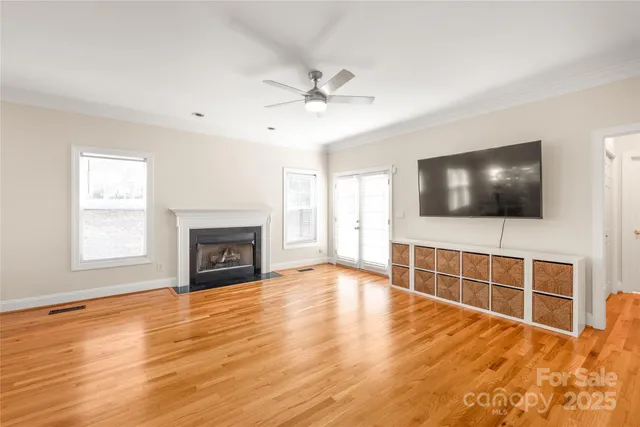a view of an empty room with a fireplace and a window