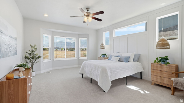 111 East Silver Oak Road Vineyard, UT 84059 - Photo 17 of 50 Spacious bedroom featuring light-colored carpeting and a ceiling fan