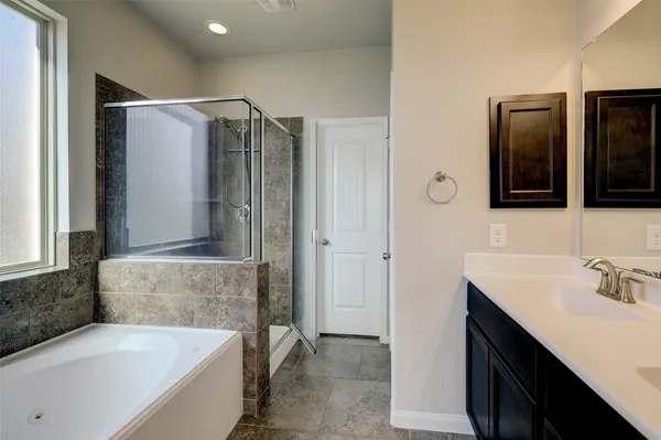 a bathroom with a double vanity sink a large mirror and a shower