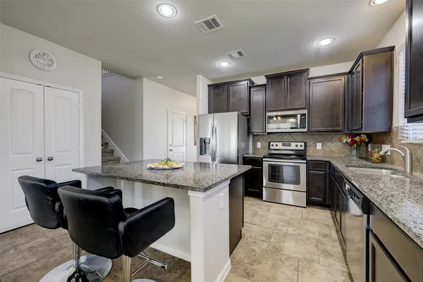 a view of kitchen island with granite countertop living room