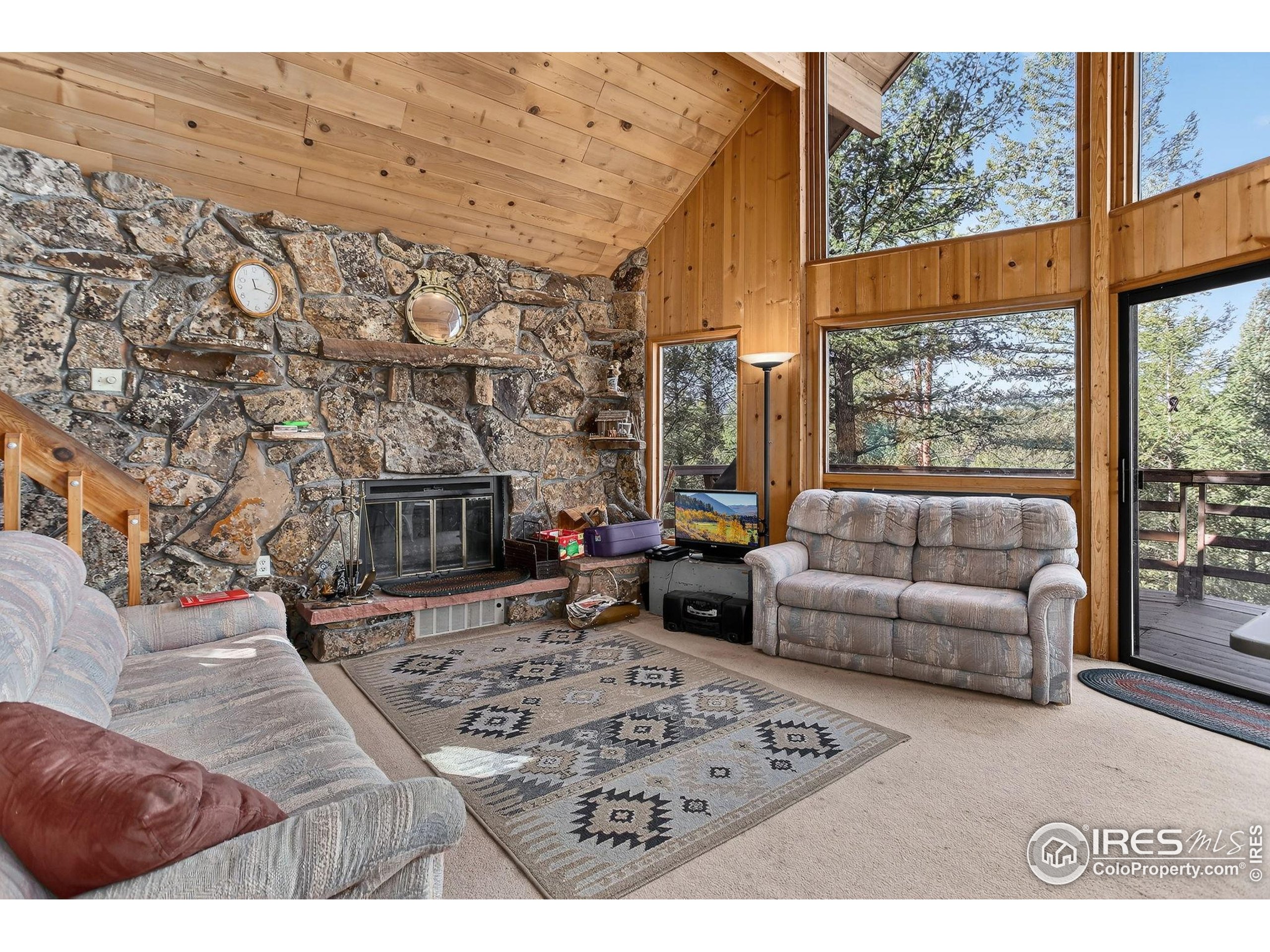 211 Hi Meadow Drive Bailey, CO 80421 - Photo 11 of 19 a living room with furniture and a fireplace