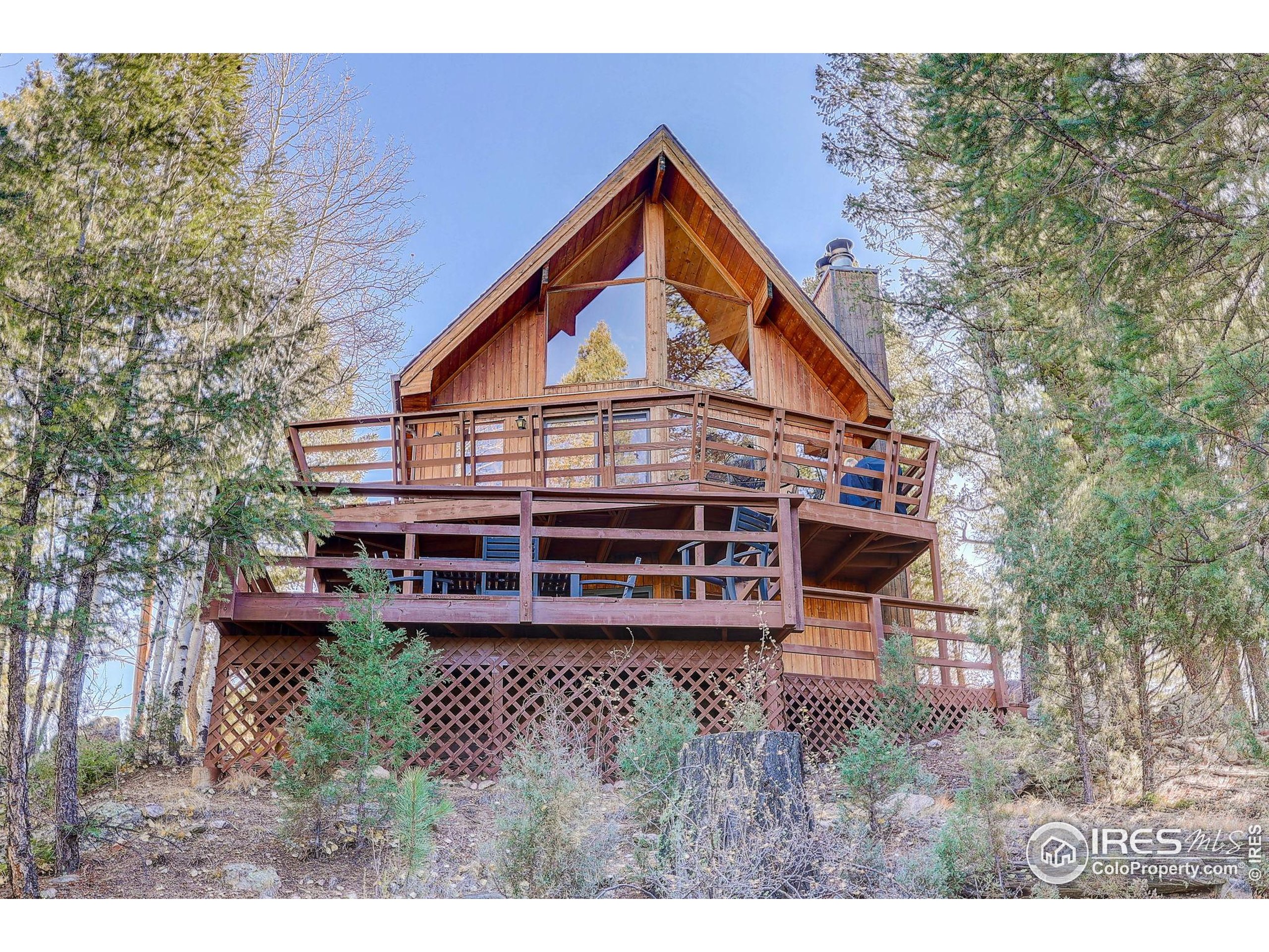 211 Hi Meadow Drive Bailey, CO 80421 - Photo 2 of 19 a view of a house with a yard and deck