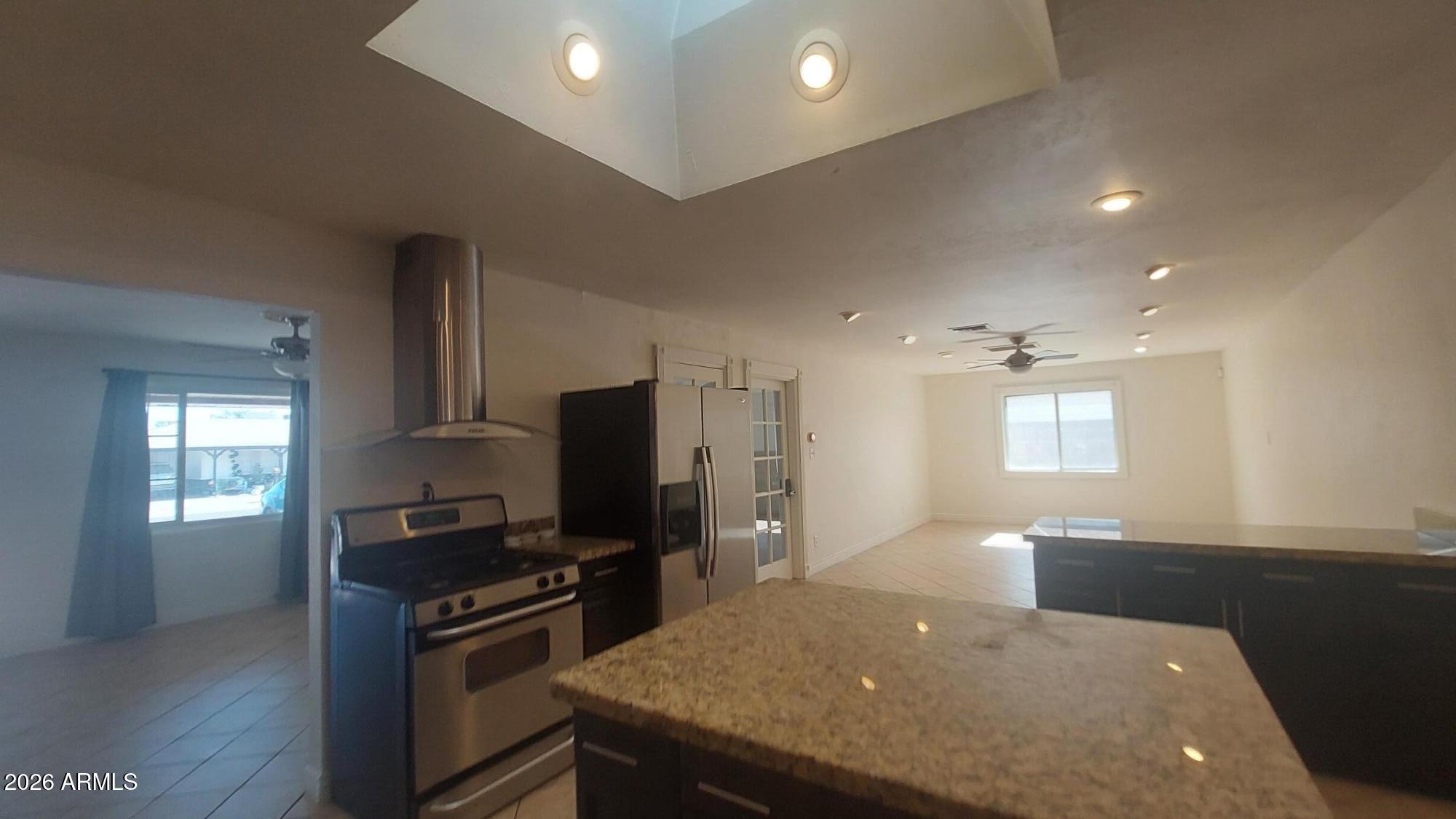2448 West Freeway Lane Phoenix, AZ 85021 - Photo 10 of 27 a kitchen with stainless steel appliances a stove a sink a refrigerator and a refrigerator
