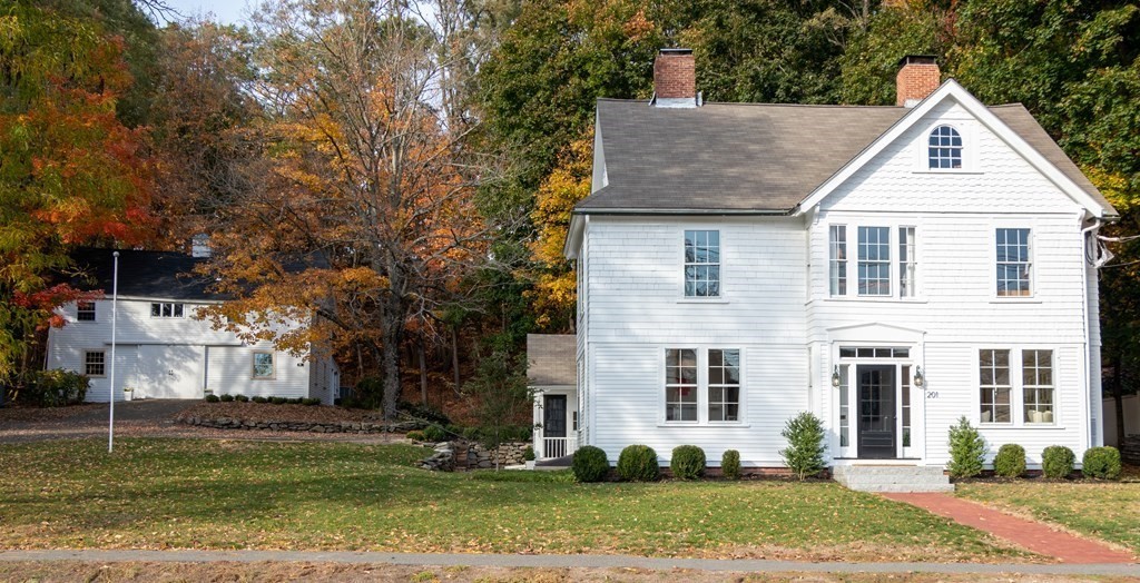 201 Lexington Road Concord, MA 01742 - Photo 1 of 41 a view of a white house next to a yard with big trees