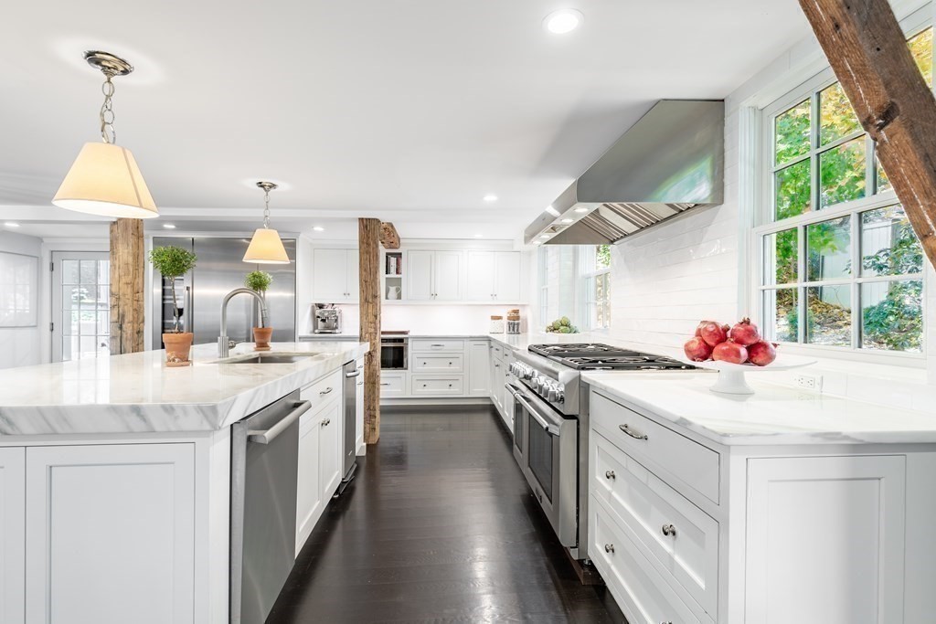 201 Lexington Road Concord, MA 01742 - Photo 13 of 41 a kitchen that has a lot of cabinets stainless steel appliances and a large window