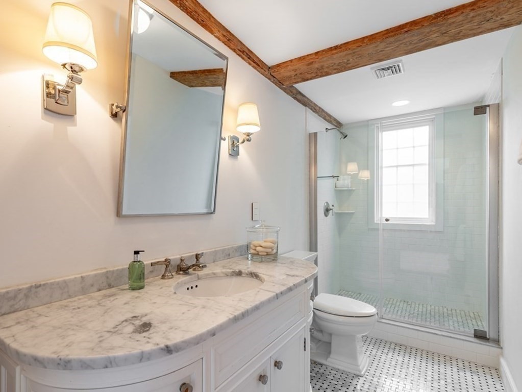 201 Lexington Road Concord, MA 01742 - Photo 29 of 41 a bathroom with a granite countertop sink a toilet and shower