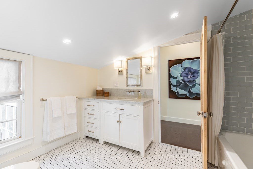 201 Lexington Road Concord, MA 01742 - Photo 31 of 41 a bathroom with a sink a mirror and a bathtub