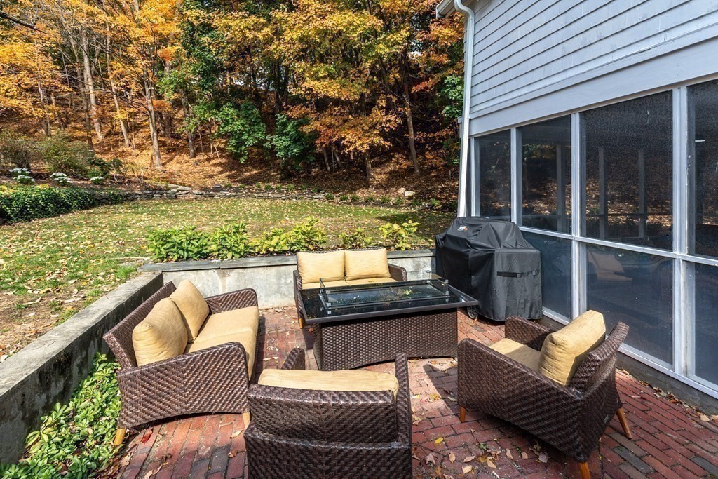 201 Lexington Road Concord, MA 01742 - Photo 33 of 41 a view of a patio with couches chairs and wooden floor