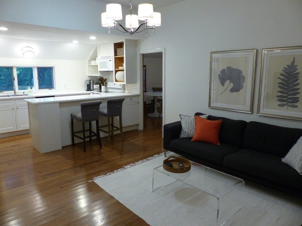 201 Lexington Road Concord, MA 01742 - Photo 36 of 41 a living room with furniture and a wooden floor