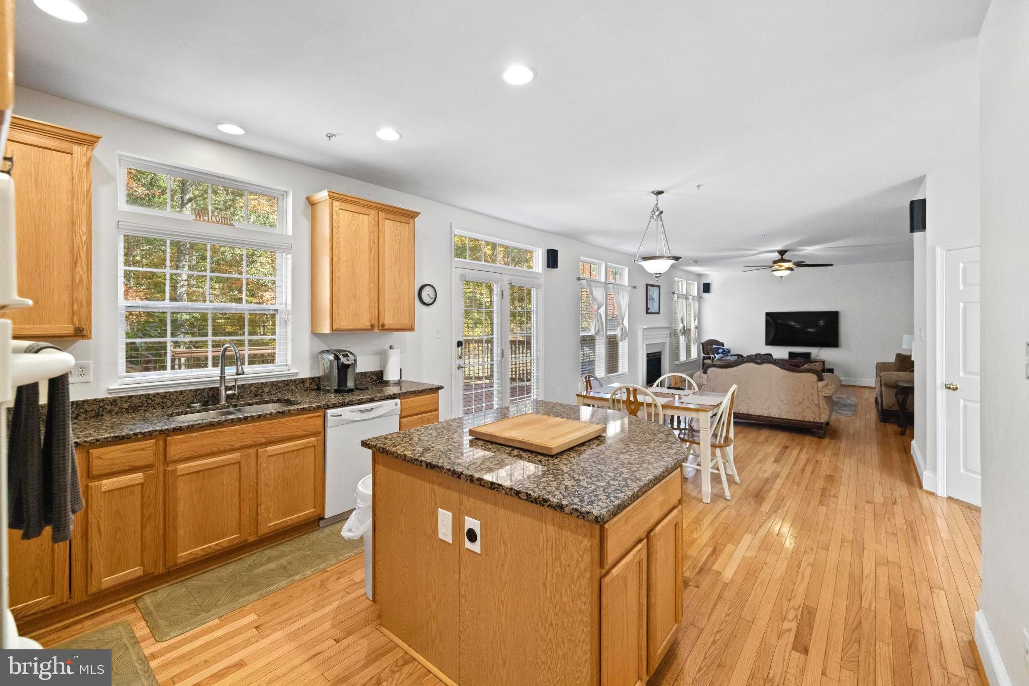 8008 Dorado Terrace Brandywine, MD 20613 - Photo 13 of 55 a kitchen with granite countertop kitchen island wooden floors and stainless steel appliances