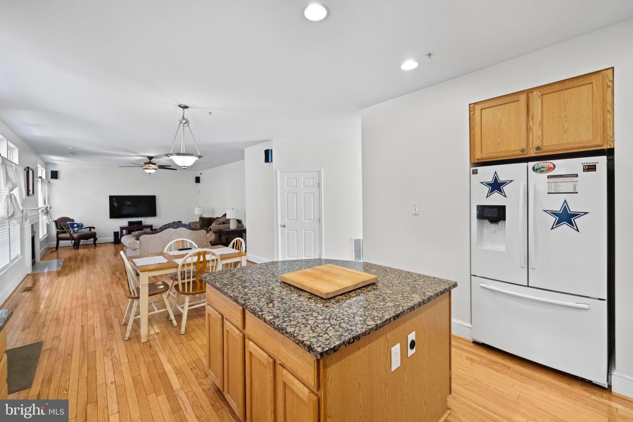 8008 Dorado Terrace Brandywine, MD 20613 - Photo 14 of 55 a open kitchen with stainless steel appliances granite countertop a refrigerator a stove and white cabinets with wooden floor