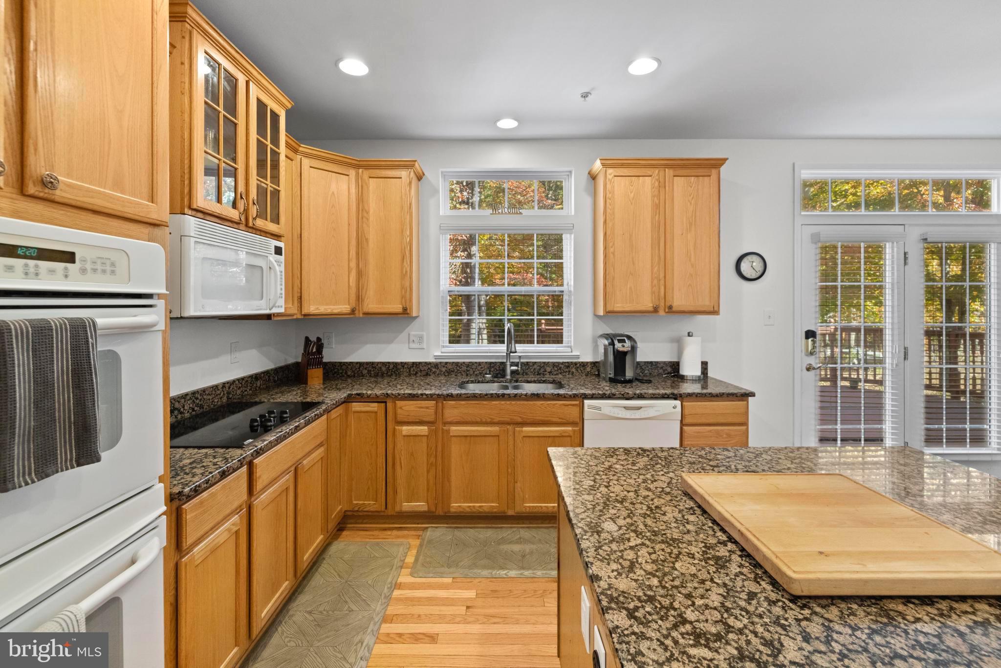 8008 Dorado Terrace Brandywine, MD 20613 - Photo 15 of 55 a large kitchen with stainless steel appliances granite countertop a stove a sink and a granite counter tops