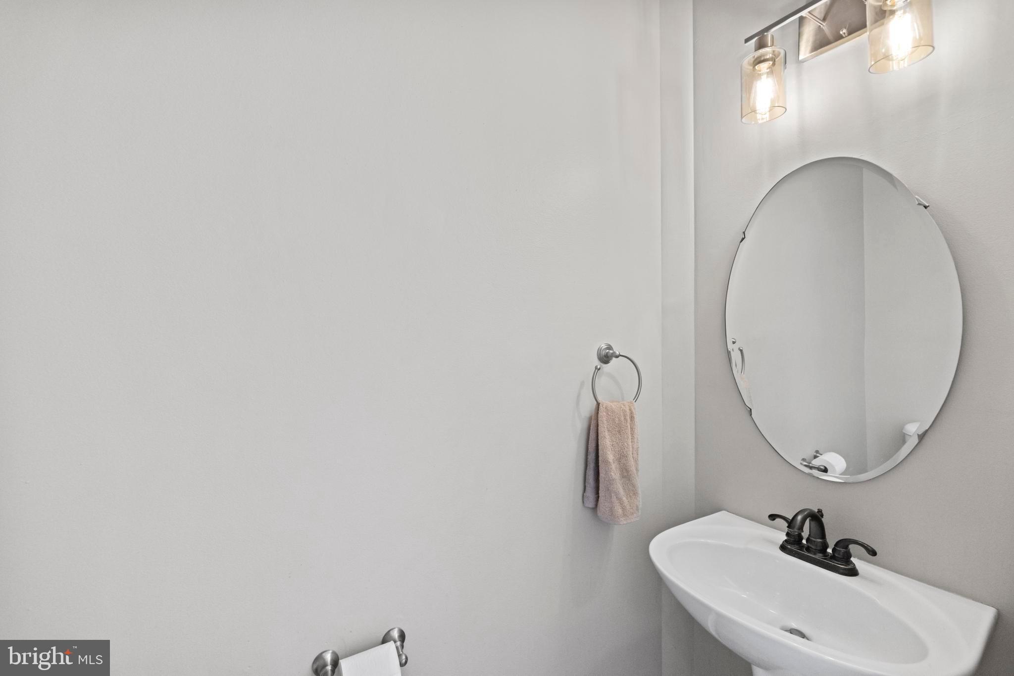 8008 Dorado Terrace Brandywine, MD 20613 - Photo 23 of 55 a bathroom with a sink and a mirror