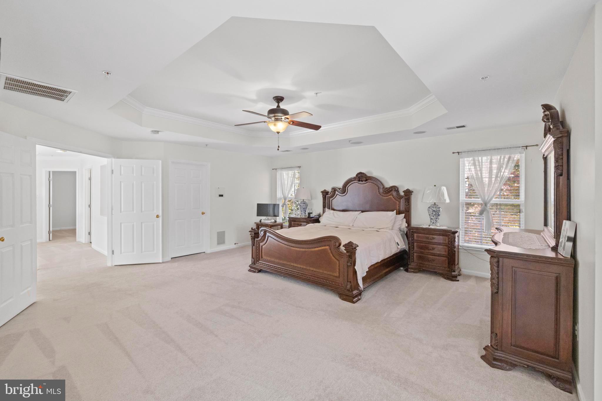 8008 Dorado Terrace Brandywine, MD 20613 - Photo 31 of 55 a spacious bedroom with a bed a chandelier and a couch