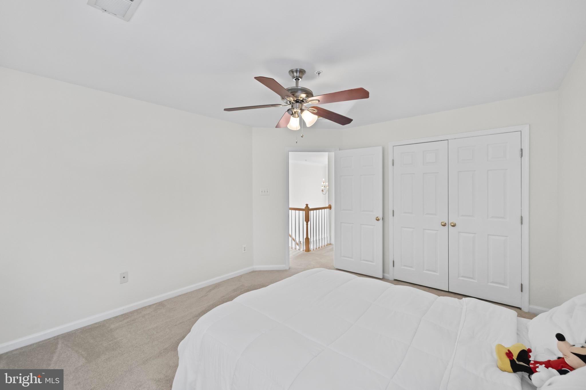 8008 Dorado Terrace Brandywine, MD 20613 - Photo 39 of 55 a bedroom with a bed and a ceiling fan