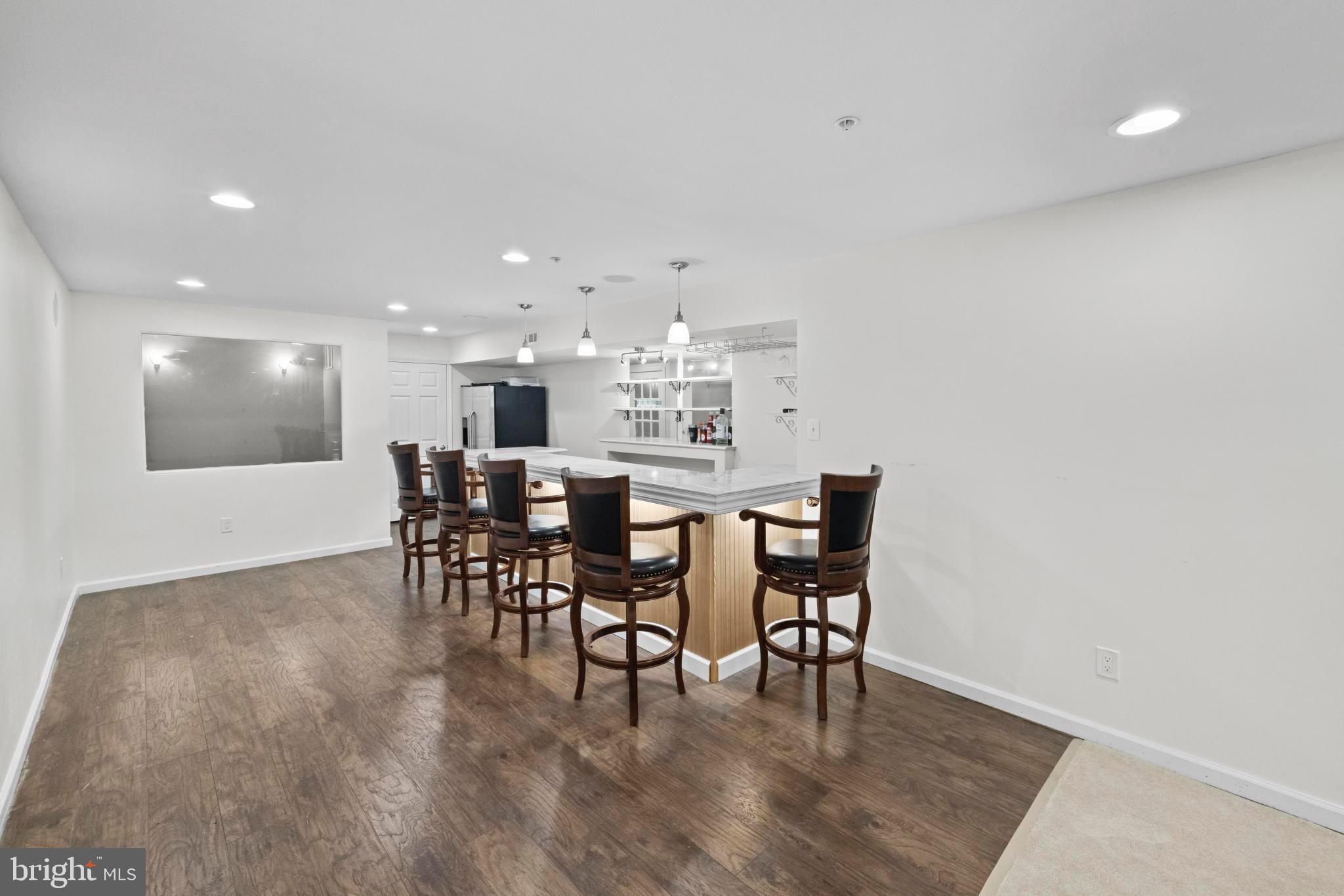 8008 Dorado Terrace Brandywine, MD 20613 - Photo 46 of 55 a dining room with furniture and wooden floor