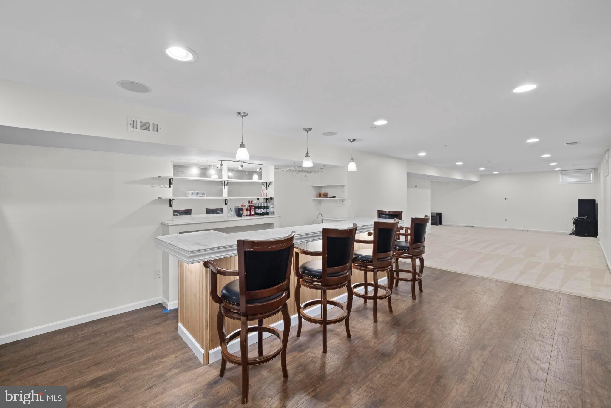 8008 Dorado Terrace Brandywine, MD 20613 - Photo 48 of 55 a kitchen with a dining table chairs wooden floor and appliances