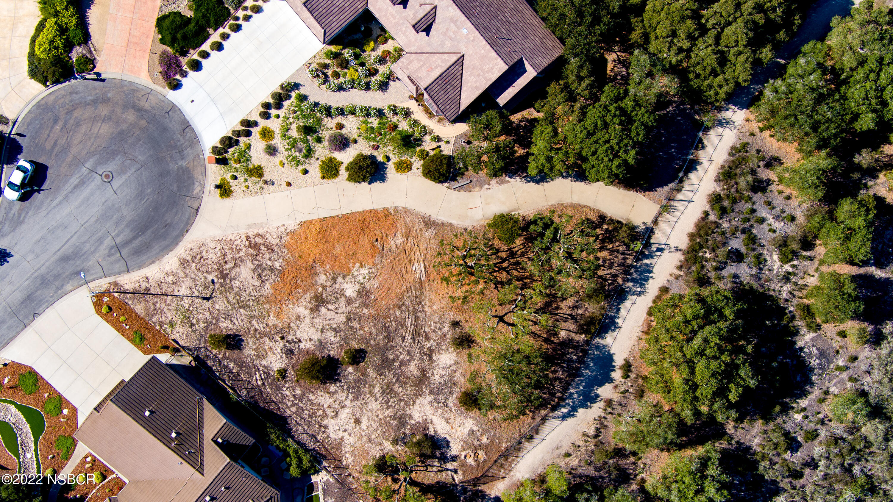 1212 Harris Drive Lompoc, CA 93436 - Photo 25 of 29 an aerial view of a house with a yard and large trees