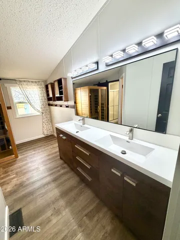 a bathroom with a double vanity sink and mirror