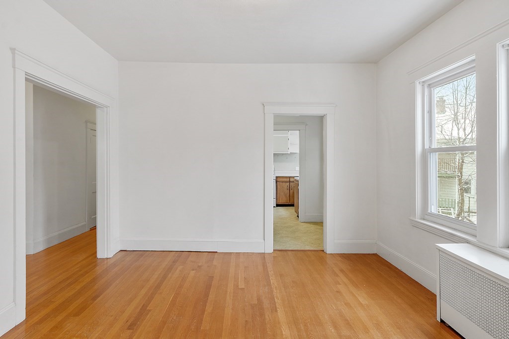 42 Radnor Road Boston, MA 02135 - Photo 11 of 17 an empty room with wooden floor and windows
