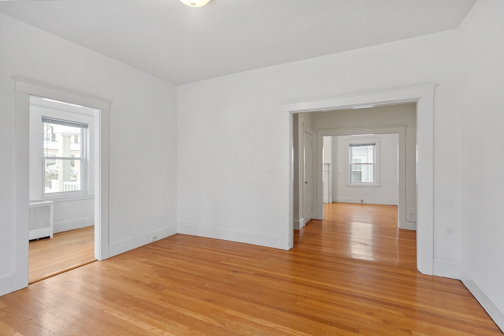 42 Radnor Road Boston, MA 02135 - Photo 10 of 17 a view of an empty room with wooden floor and a window