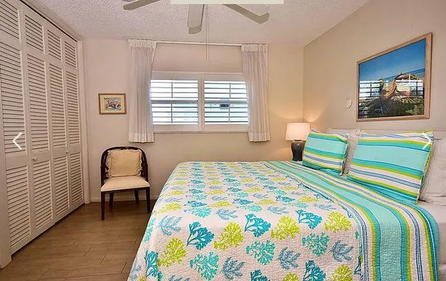 a bedroom with a bed and a chair